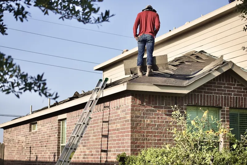 Professional roofer working on a residential roof in Shazen
